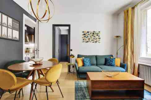 Modern living room in Courcelles Pearl Suite with stylish furniture and decor.