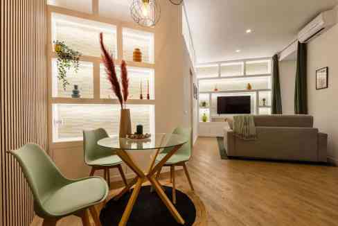 Stylish living room with modern furniture, decorative shelves, and warm lighting.