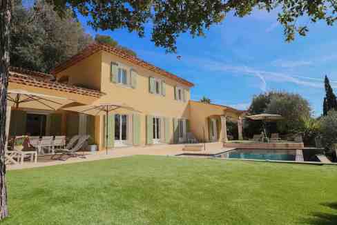 Luxury villa with garden, pool, and outdoor seating in Antibes.