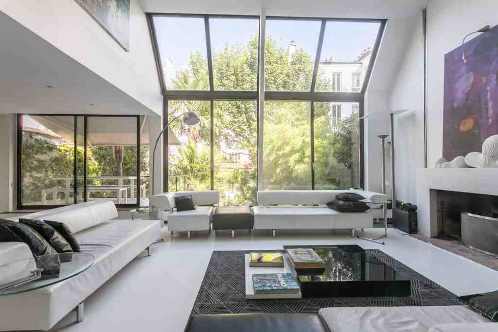 Spacious modern living room with large windows and contemporary furniture.