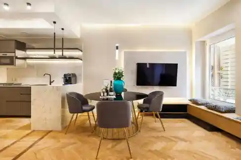 Contemporary living and dining space with sleek kitchen and cozy seating area.