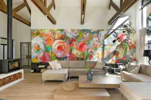 Bright, stylish interior featuring a vibrant floral mural and natural light.