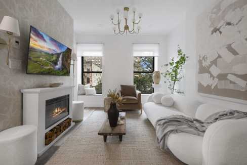 Contemporary living room with fireplace, large windows, and stylish decor.