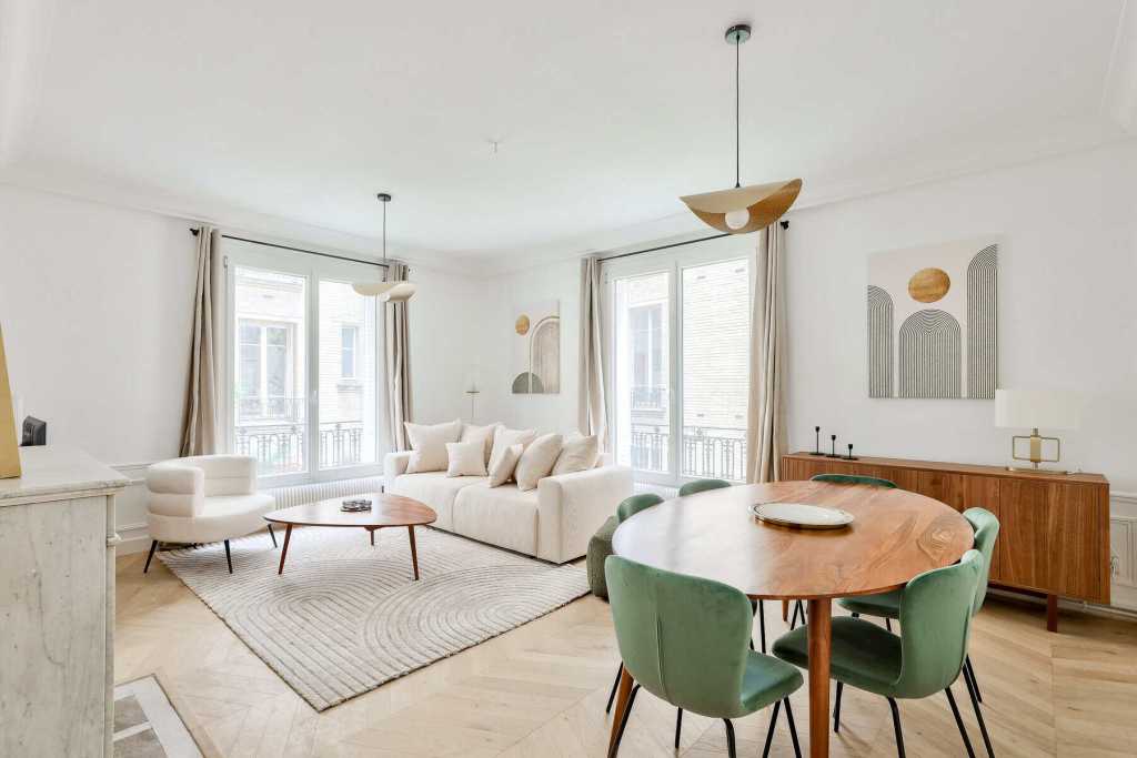 Bright living room with large windows, white sofa, and contemporary decor.