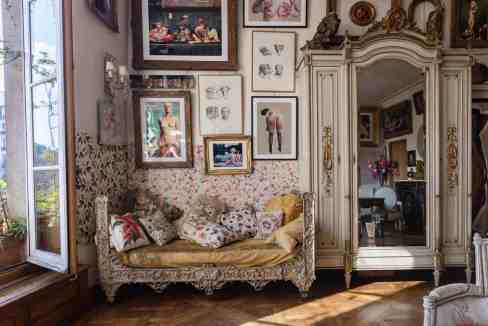 Vintage living room with ornate furniture and art collection.