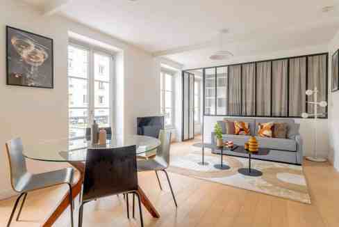 Bright living room with large windows, stylish furniture, and contemporary decor.