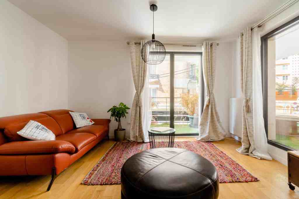 Bright living room with large windows and terrace access in Clichy.