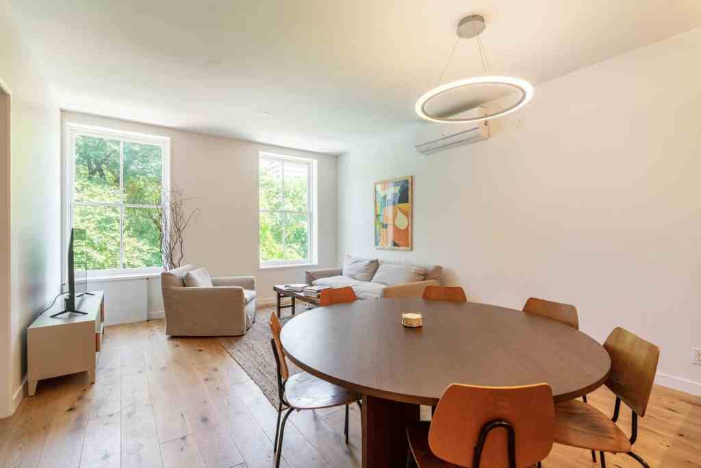 Bright living room featuring large windows, contemporary furniture, and minimalist decor.