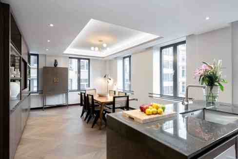 Bright, modern serviced apartment with open kitchen and dining area.