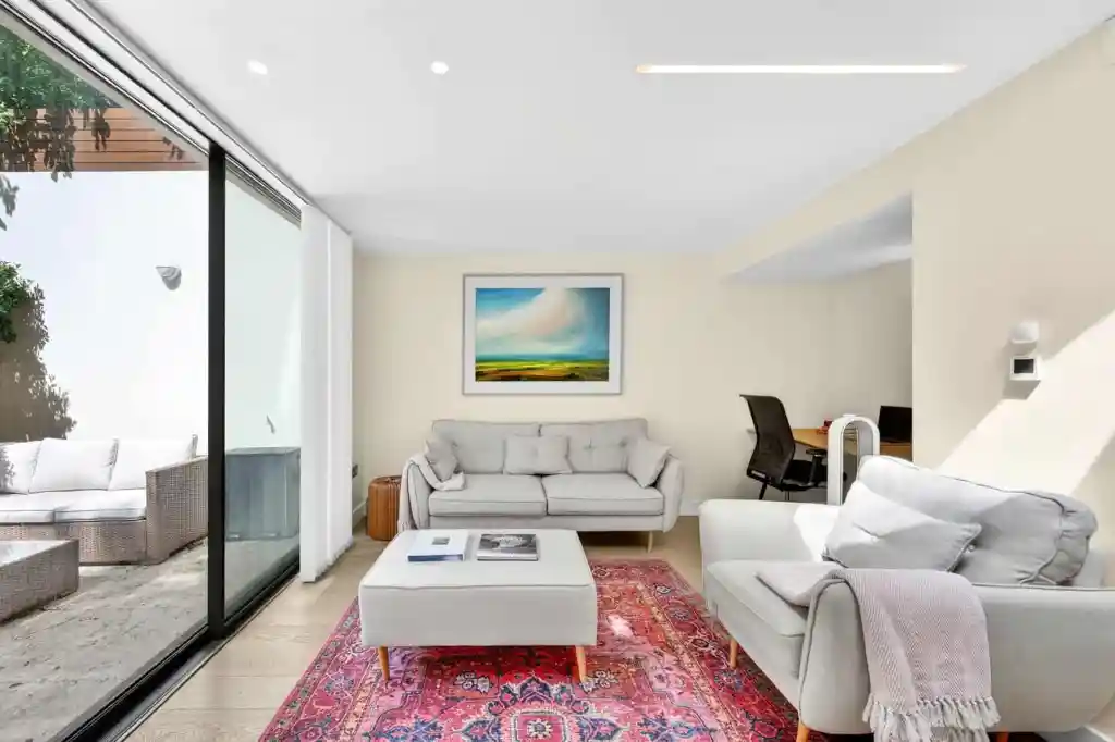 Bright living room with large glass doors and contemporary furniture.