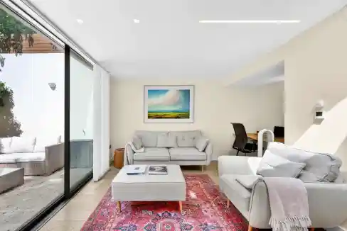 Bright living room with large glass doors and contemporary furniture.