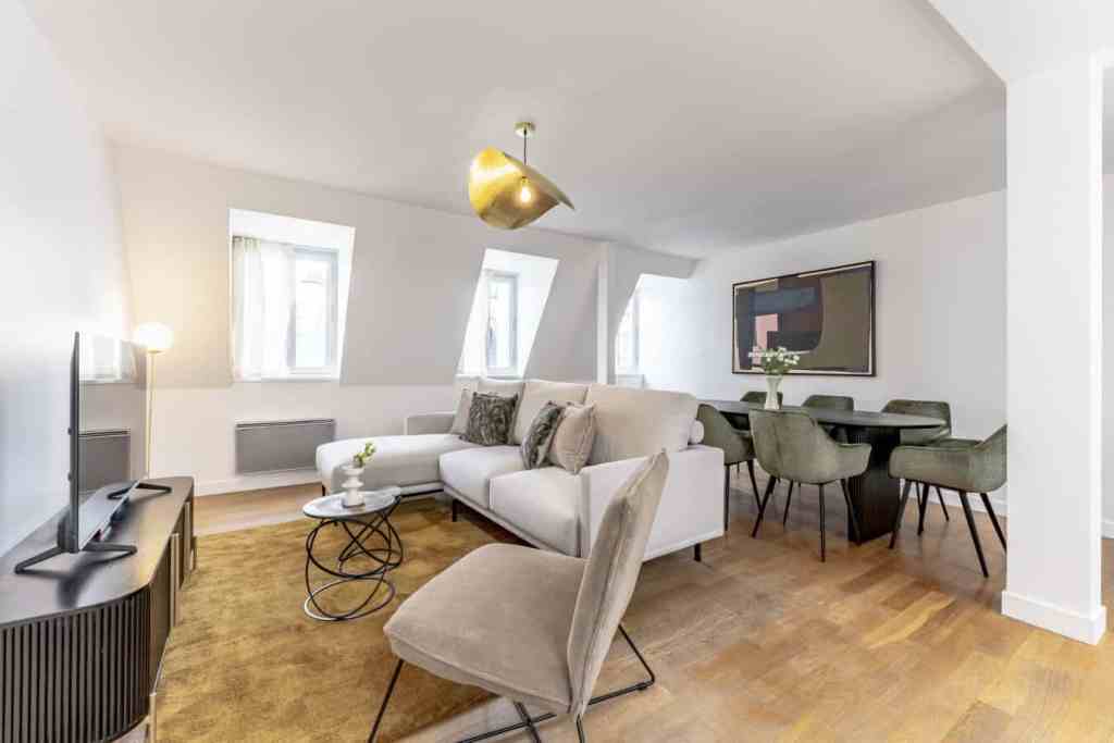Bright living room with white walls, large windows, and contemporary furniture.