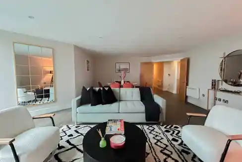 Modern living room with white sofa and black accents in Vauxhall Riverlight Suite.