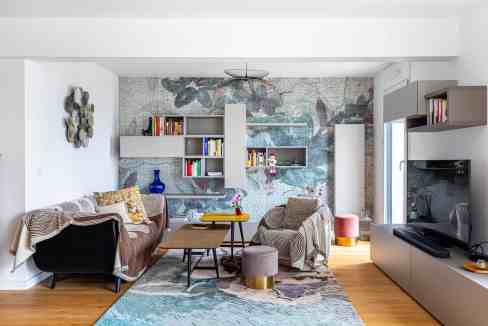 Contemporary living room with colorful wall art, cozy seating, and modern decor.