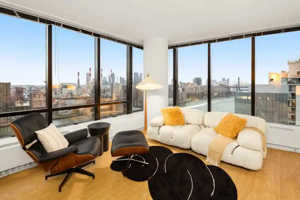 City skyline view from a modern high-rise apartment living room.