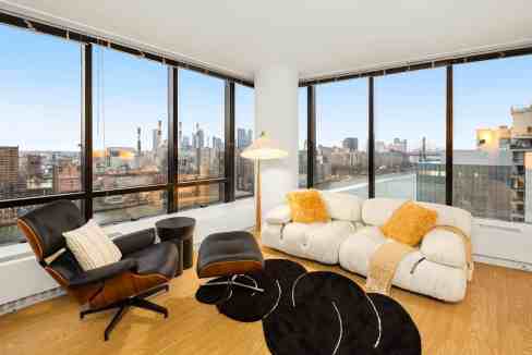 City skyline view from a modern high-rise apartment living room.