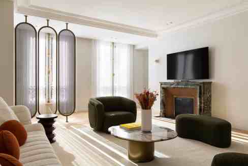 Spacious living room with contemporary furniture and a fireplace.