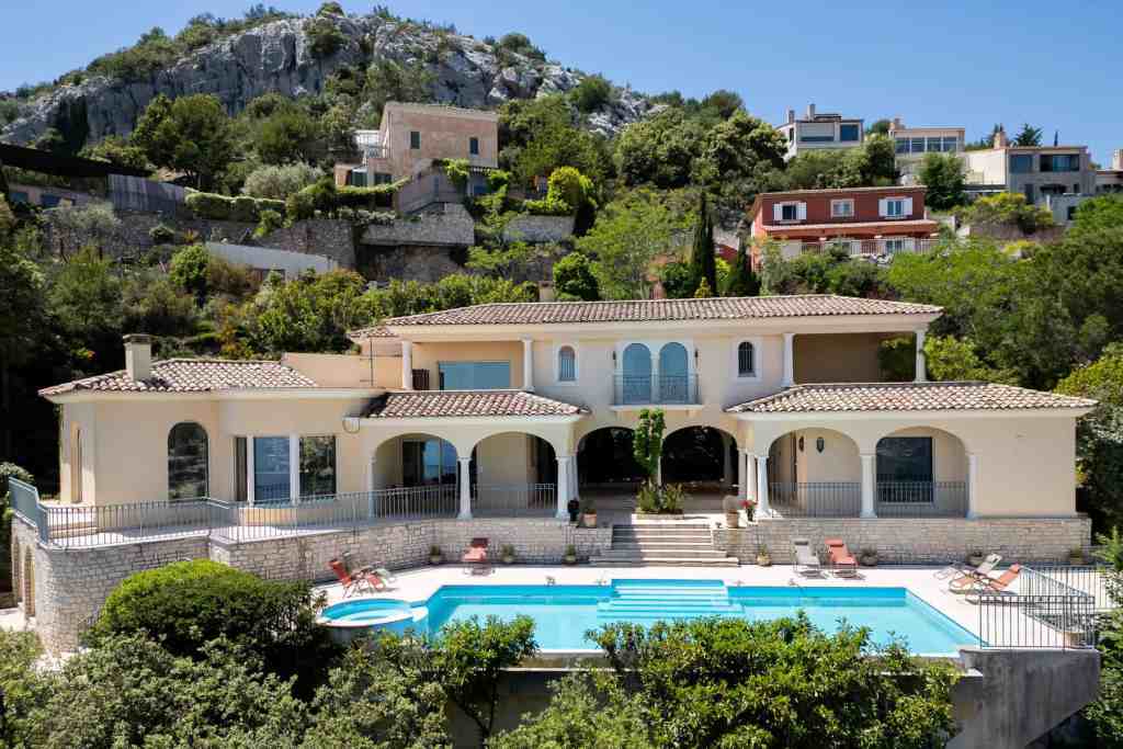Elegant villa with swimming pool and scenic hillside view in Monte Carlo.