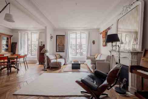Spacious and stylish living room with classic decor and large windows in Montmartre.