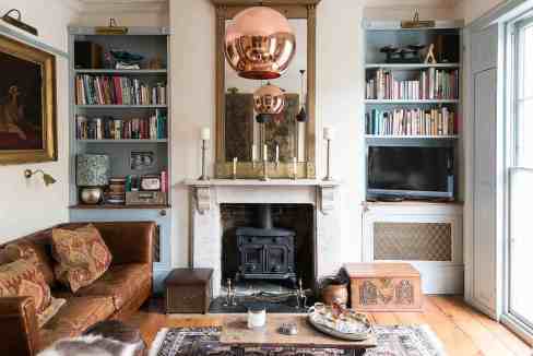 Elegant living room with fireplace, bookshelves, and vintage decor in Clerkenwell.