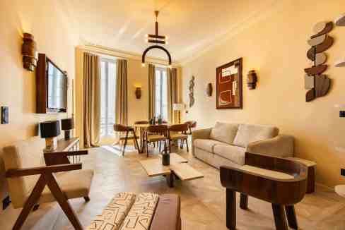 Stylish living room with modern furniture and artwork in Élysée Opéra House.