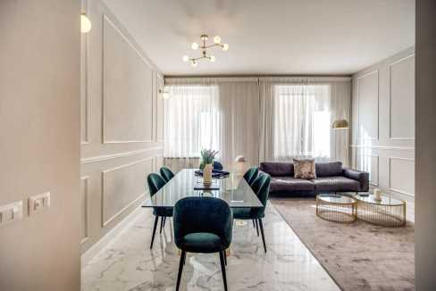 Contemporary living and dining space featuring sleek furniture, soft lighting, and stylish decor.