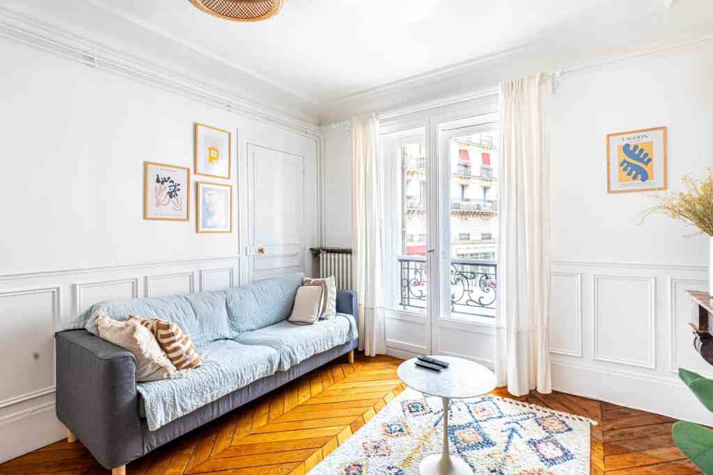 Bright living room with large windows and elegant decor.