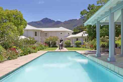 Luxury mountain retreat with a private pool, lush garden, and scenic mountain views. Perfect for rel.