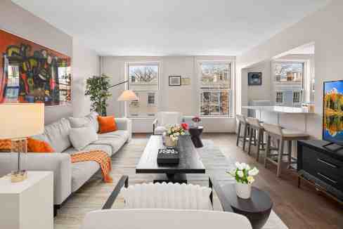 Bright living room with large windows, contemporary furniture, and colorful decor accents. Perfect f.