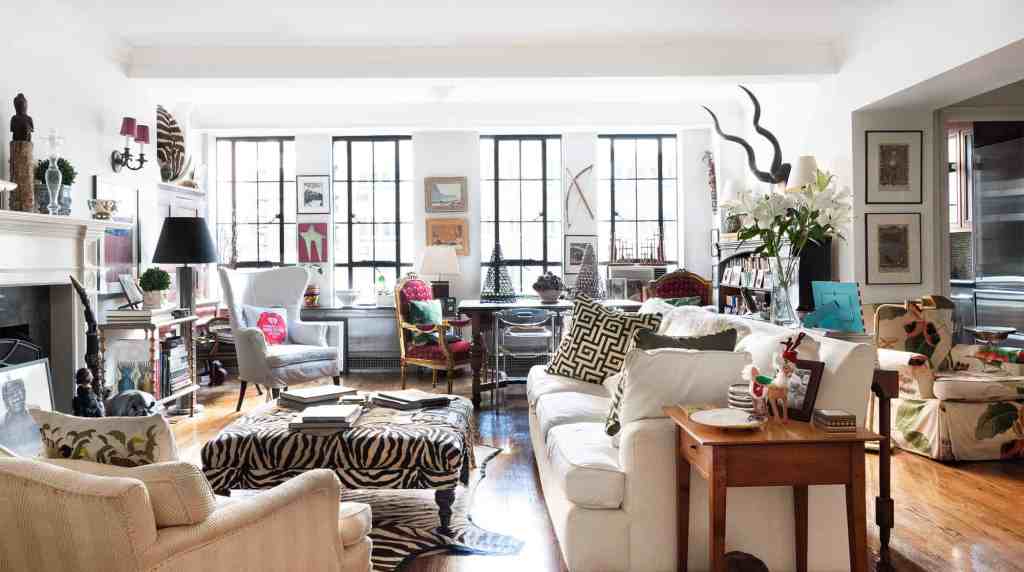 Bright eclectic living room with colorful furniture, artwork, and decorative accessories in a spacio.