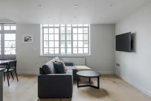 Modern living room with large windows and minimalist decor.