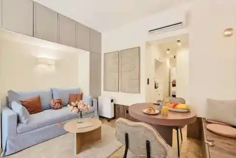 Modern serviced apartment interior with cozy living area and dining space.