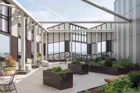 Modern rooftop terrace with seating and greenery in Croydon Skyline Suite.