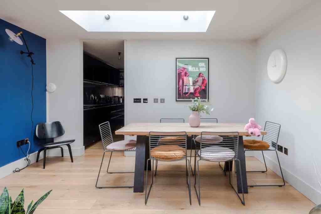 Contemporary dining area with wooden table and mixed chairs in Covent Garden Penthouse.