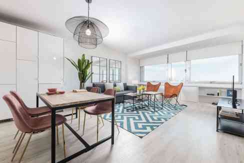 Bright living room featuring contemporary furniture, large windows, and stylish decor for a welcomin.