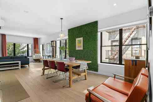 Bright and airy living space with contemporary furniture and a green accent wall.