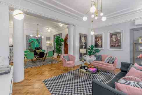 Stylish living room featuring contemporary furniture, artwork, and lush greenery in a bright, spacio.