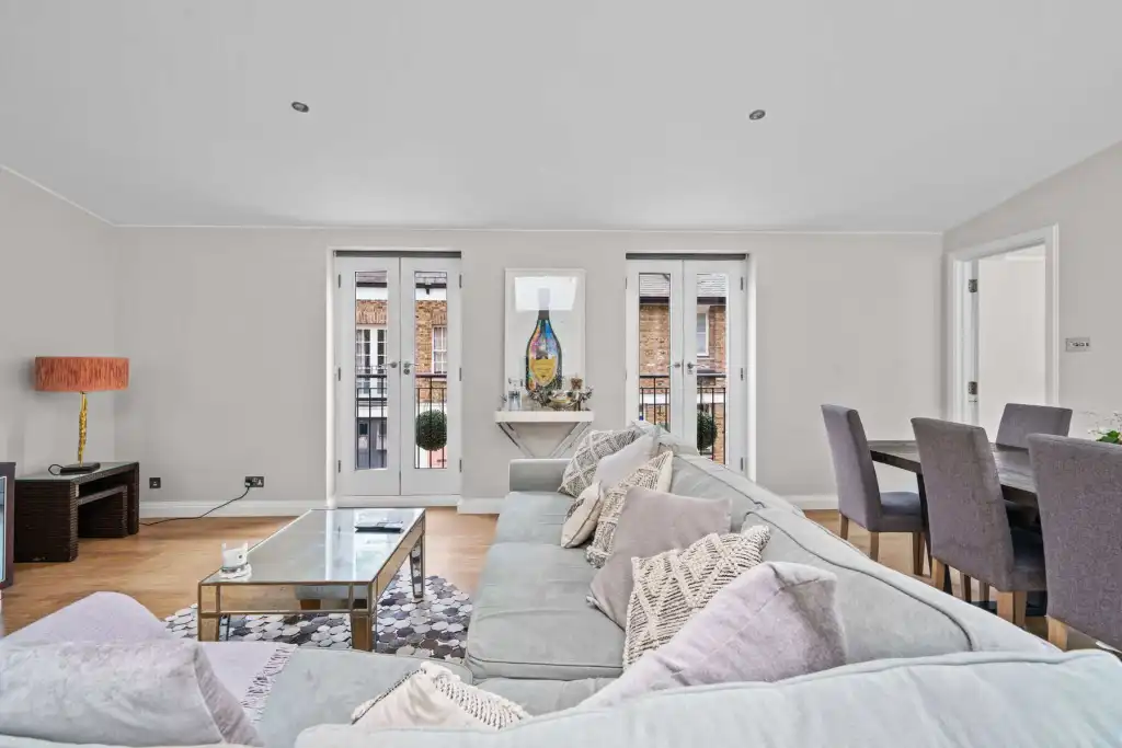 Bright, spacious living room with large windows and contemporary decor.
