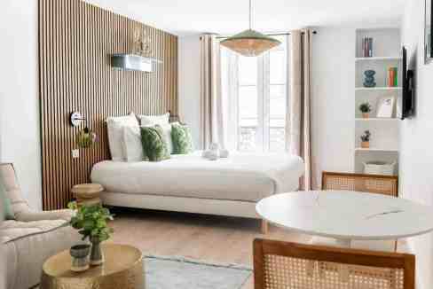 Bright modern bedroom with minimalist design, natural light, and cozy decor elements.