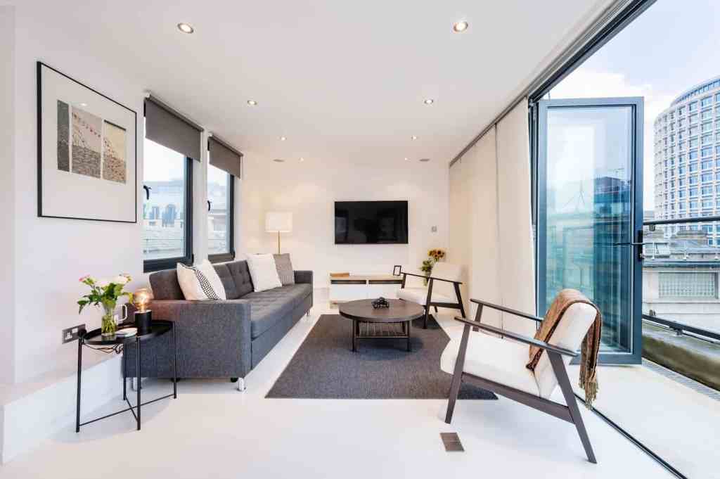 Bright, modern living room with large windows and city views.