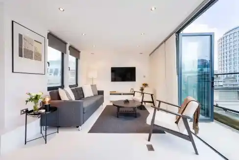 Bright, modern living room with large windows and city views.
