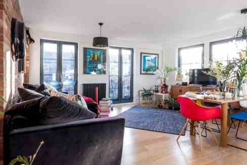 Bright and spacious living room with large windows and contemporary decor.