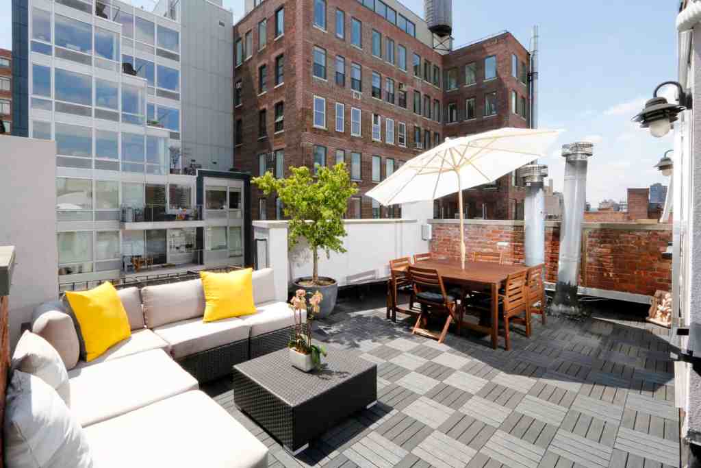 Rooftop terrace with seating, umbrella, and city views in Chelsea.