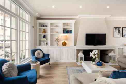 Stylish living room with large windows, modern furniture, and decorative accents.