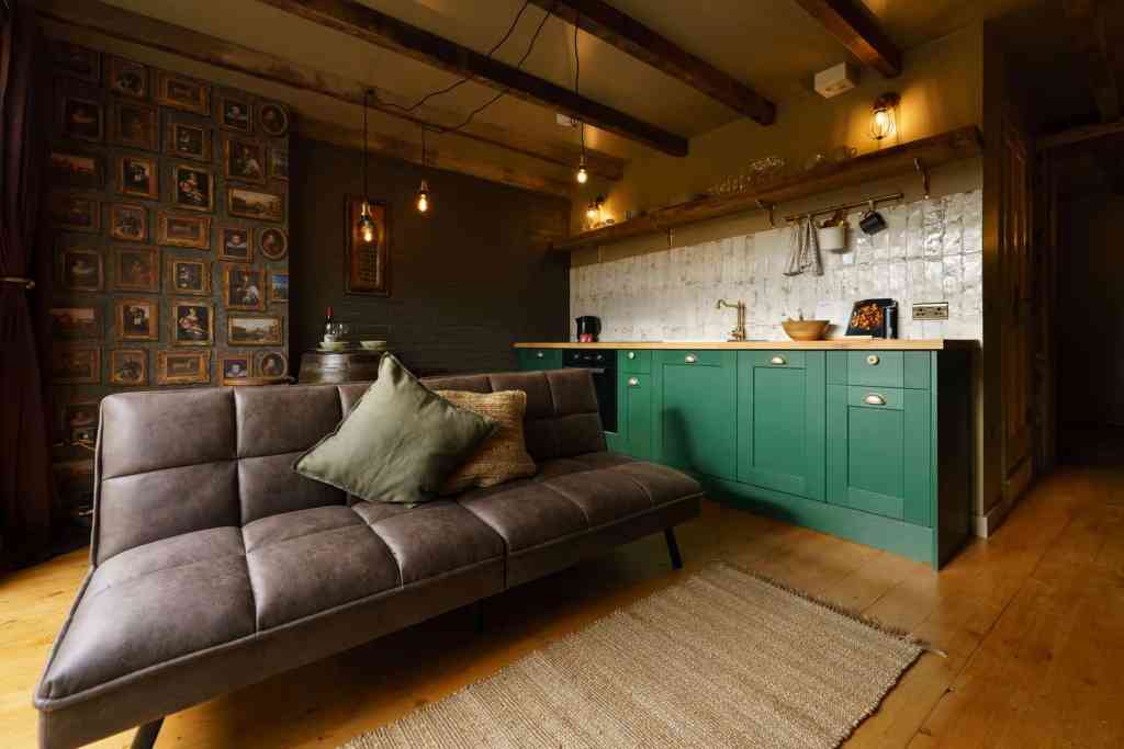 Stylish Victorian loft living room with modern kitchen and cozy sofa.