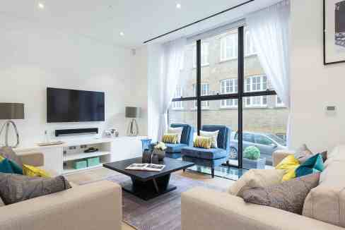 Bright, stylish living room with large windows and contemporary furniture.