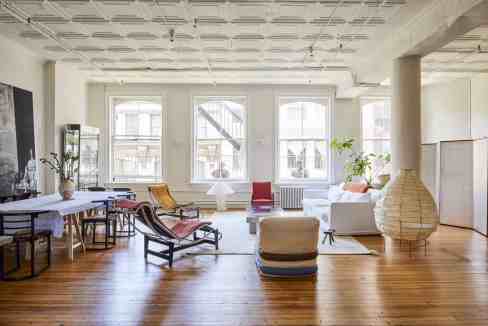 Bright, spacious living room with large windows and modern decor in Tribeca.