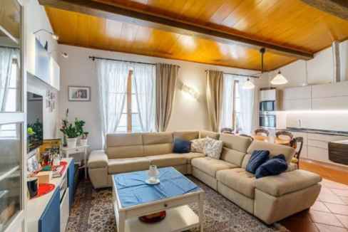 Spacious living room with beige sectional sofa and wooden ceiling in Palazzo Florence Poise.