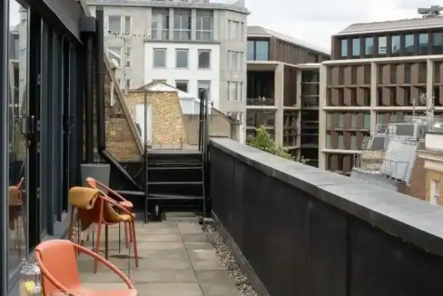 Contemporary London skyline with modern buildings and a balcony view.