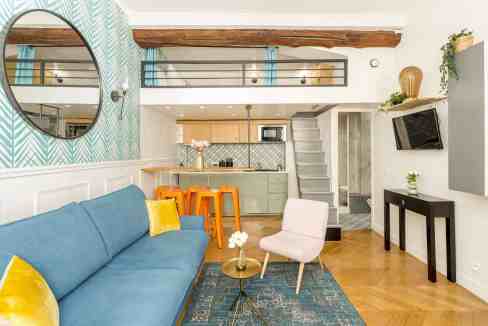 Modern Paris loft with open-plan living area and mezzanine.